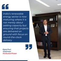 Ratul Puri standing in an office alongside a quote about India’s renewable energy sector shifting from rapid expansion to execution-led growth and reliable clean energy delivery.